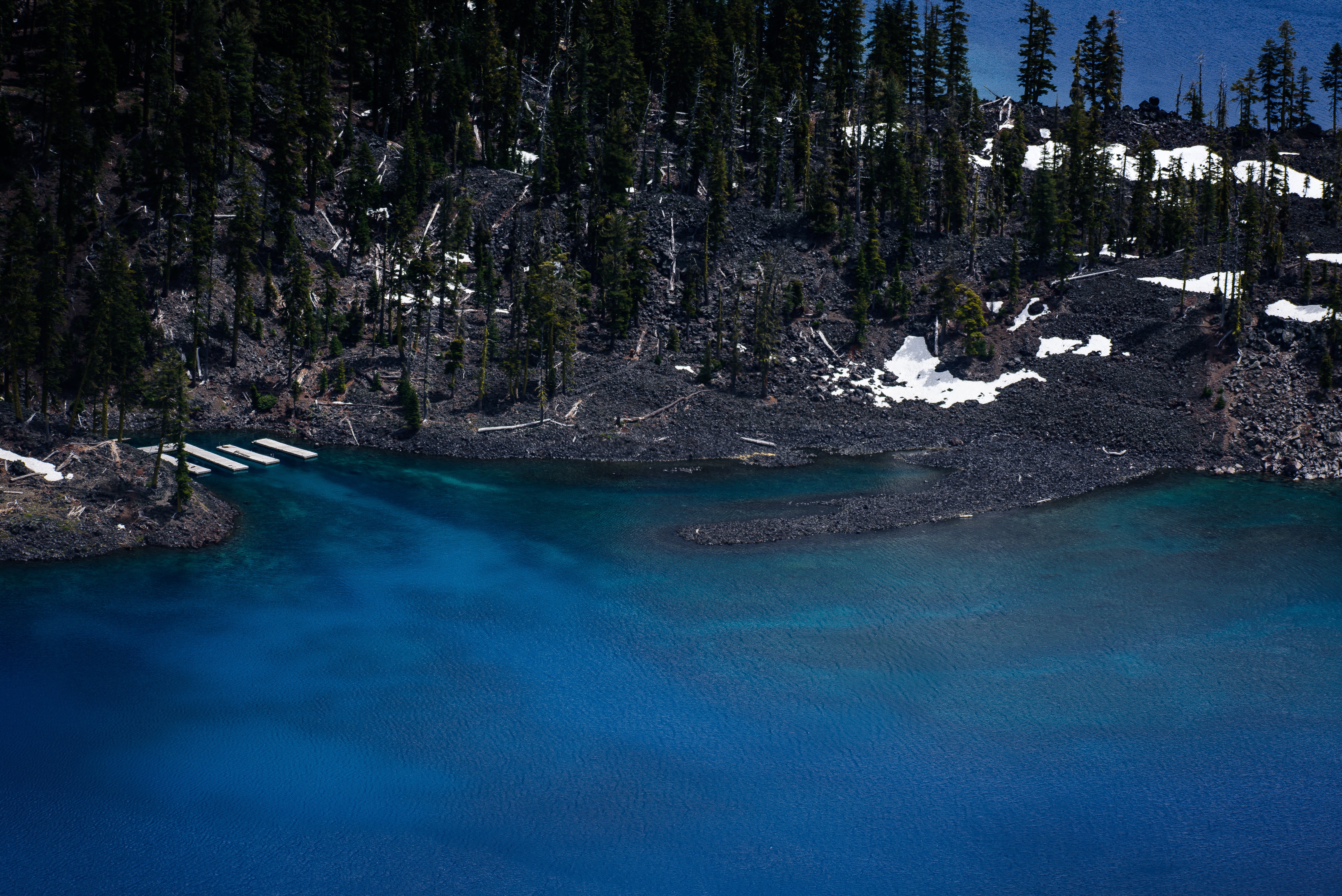 blue body of water near hills