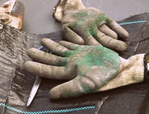 photo of white gloves with green stained colors thumbnail
