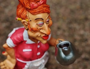 female waitress with pencil on ear holding pitcher ceramic figurine thumbnail