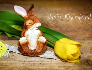 brown rabbit figurine yellow butterfly and yellow flower thumbnail