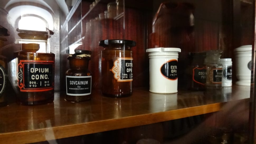 black labeled containers on brown wooden shelf preview