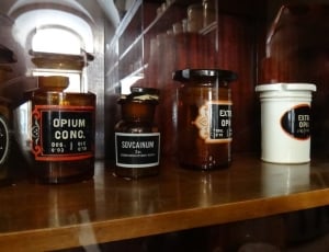 black labeled containers on brown wooden shelf thumbnail