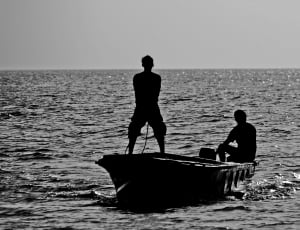silhouette of 2 man in boat thumbnail