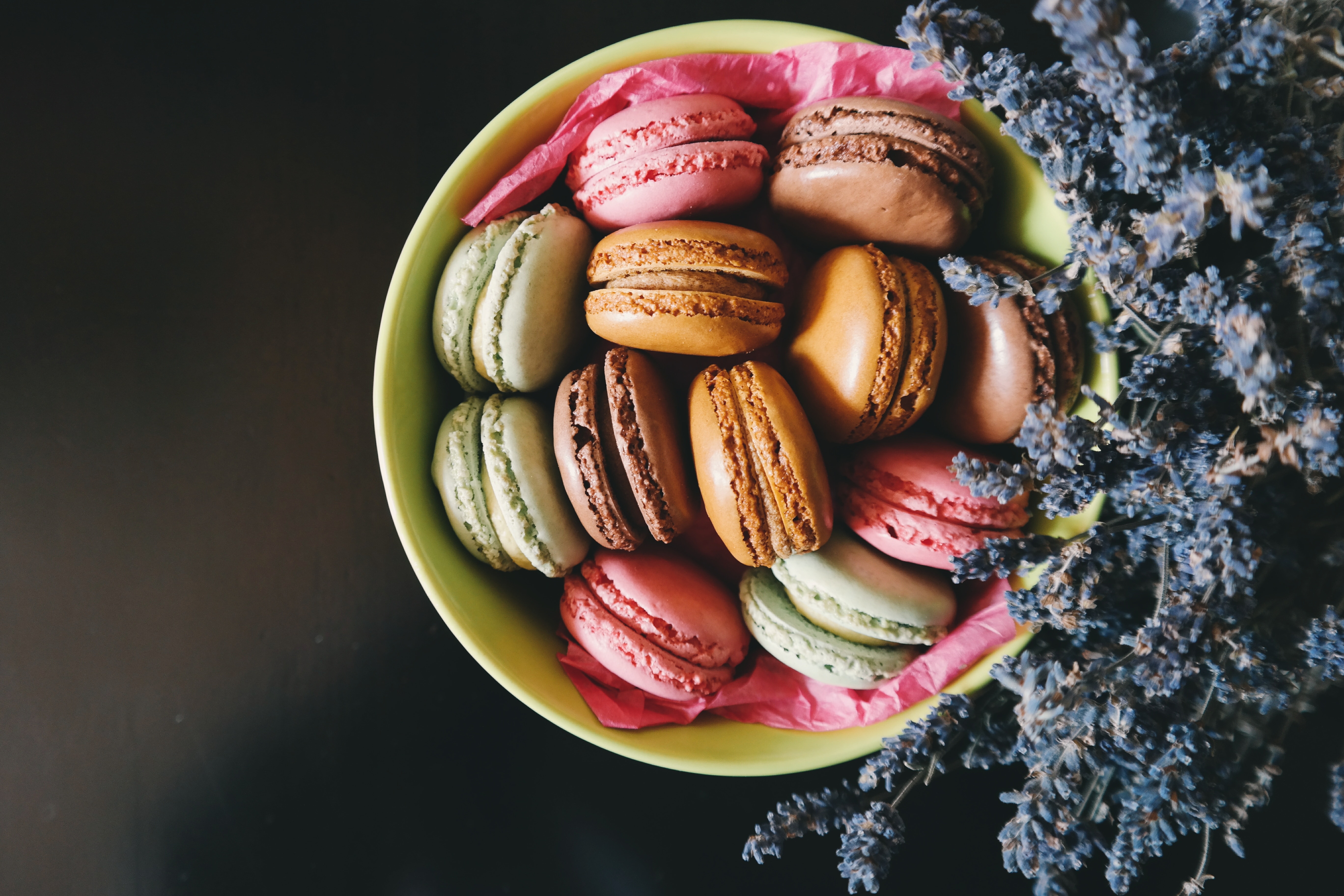 assorted sweet cookies on a green ceramic bowl