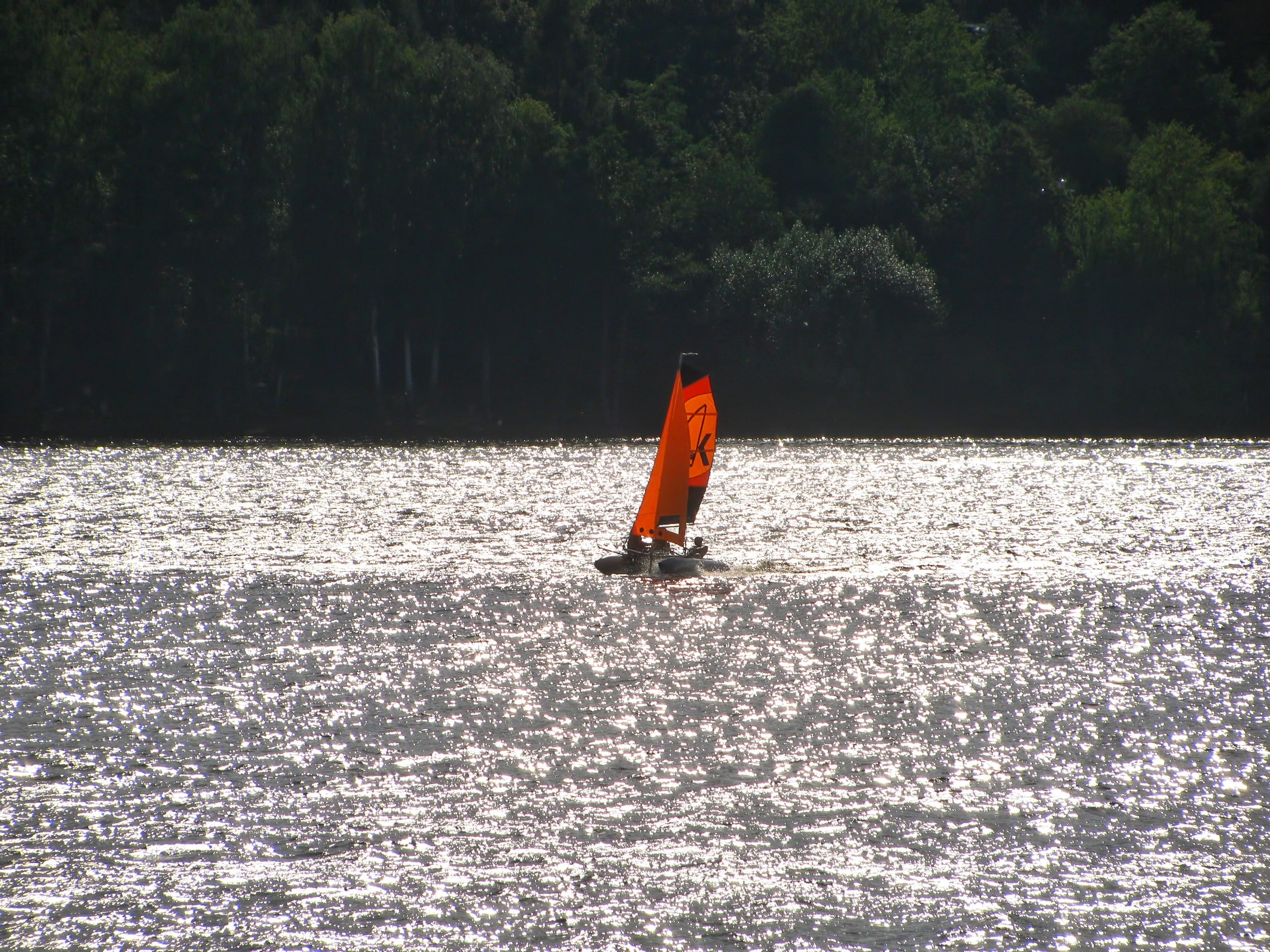 black and orange camataran boat
