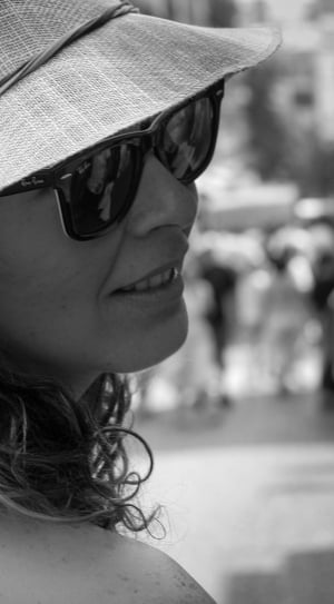 grayscale photography of women wearing sunhat and wayfarer sunglasses thumbnail