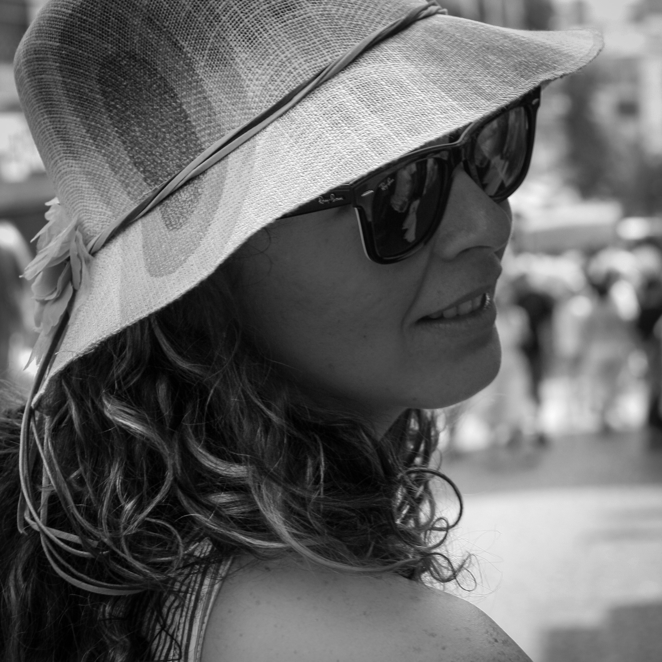 grayscale photography of women wearing sunhat and wayfarer sunglasses