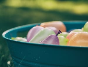 green orange and purple balloons with water in bucket thumbnail