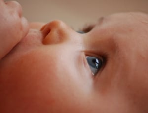 toddler looking up while her left hand on top her mouth thumbnail