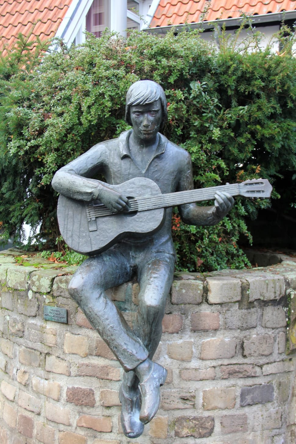 man playing guitar statue preview