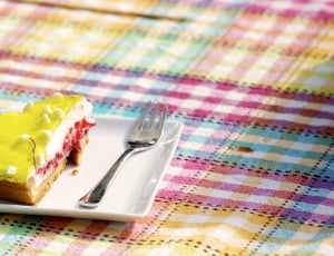 pastry near stainless steel fork on white ceramic plate thumbnail