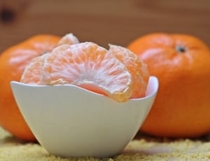 orange fruits on white round bowl thumbnail