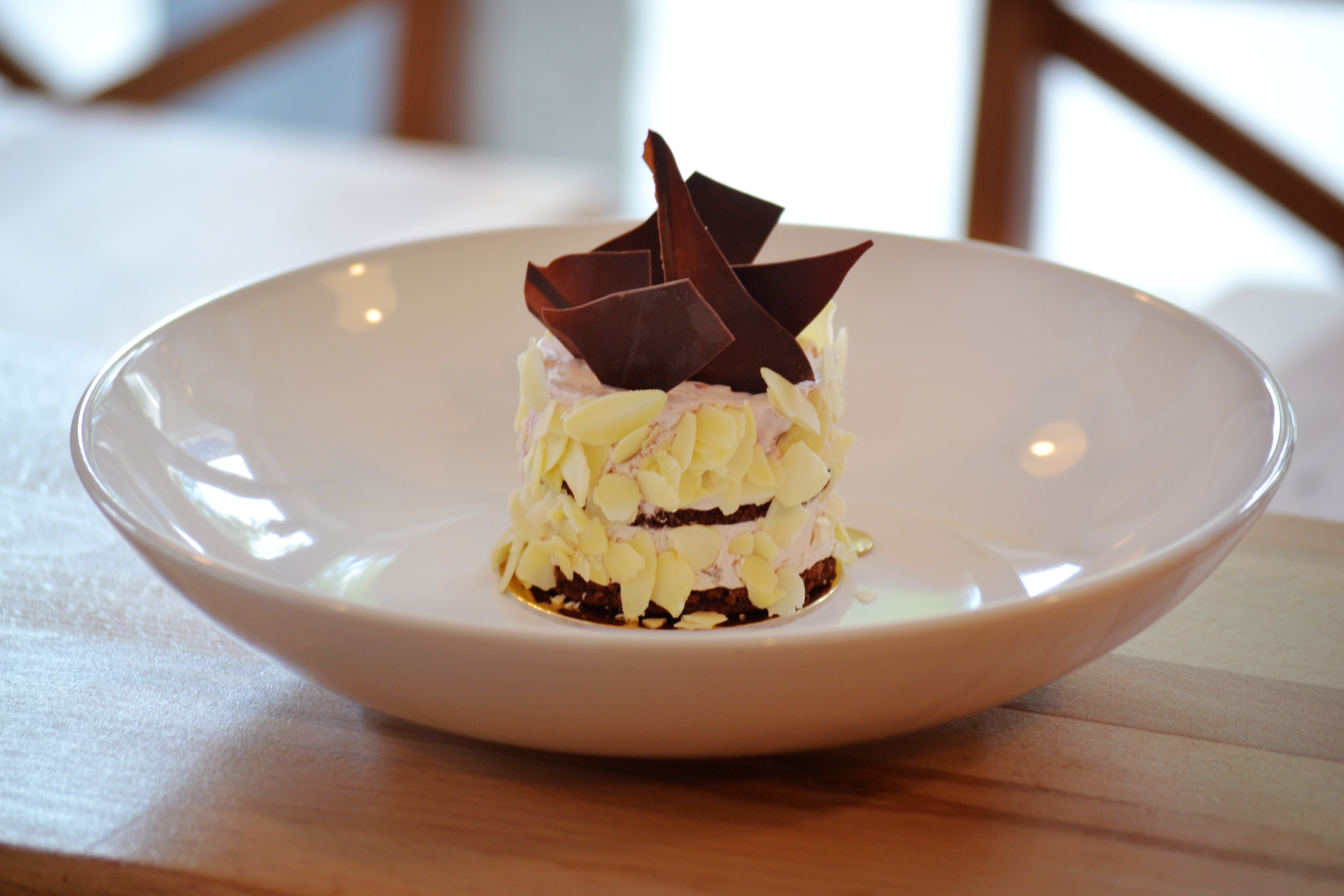 chocolate pastry on white ceramic bowl on top of brown wood surface on selective focus photography