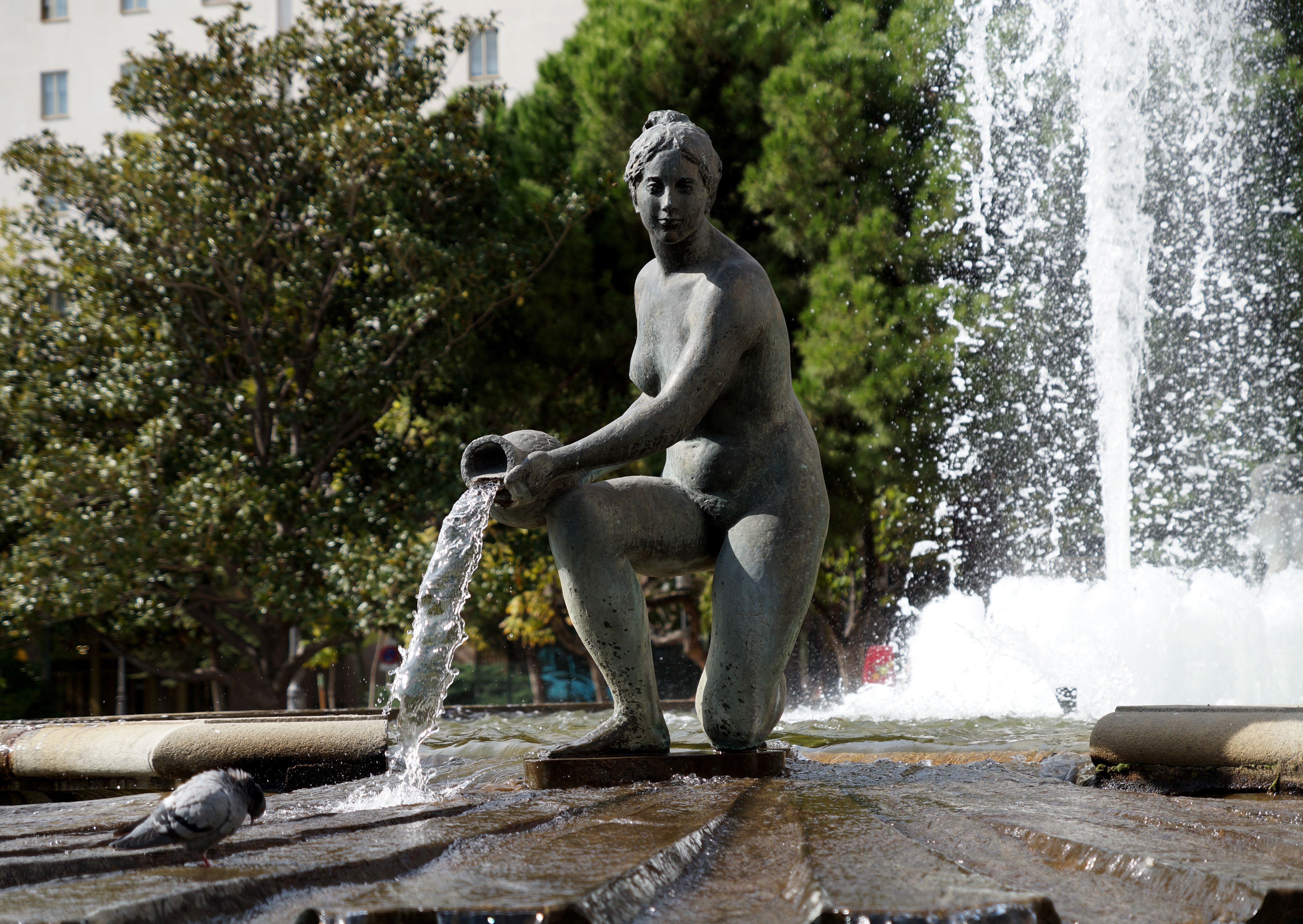 grey statue near fountain