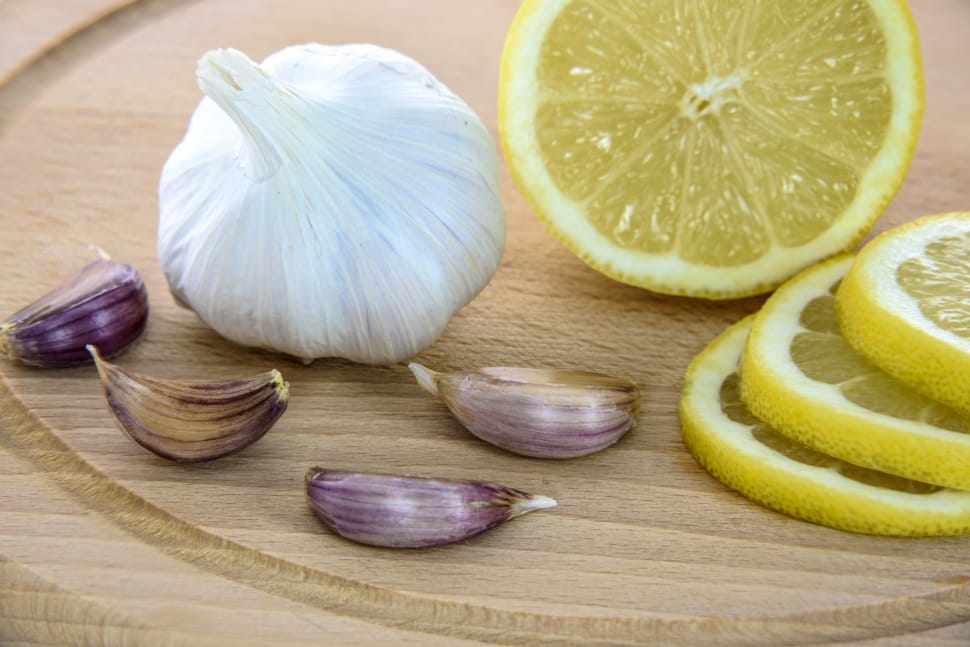 garlic with onions and lemon on top of chopping board preview