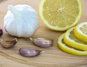garlic with onions and lemon on top of chopping board thumbnail