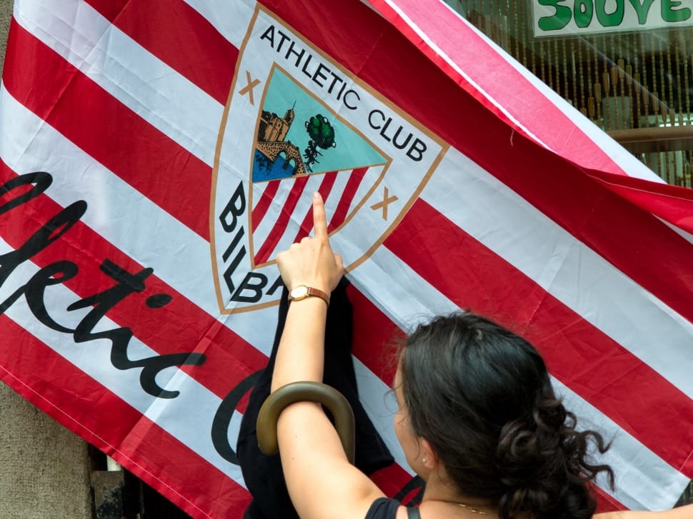 woman pointing Athletic Club Bilba flag preview