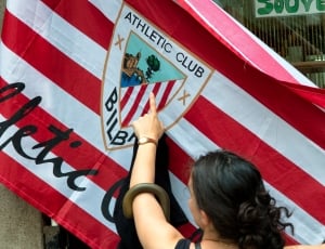 woman pointing Athletic Club Bilba flag thumbnail