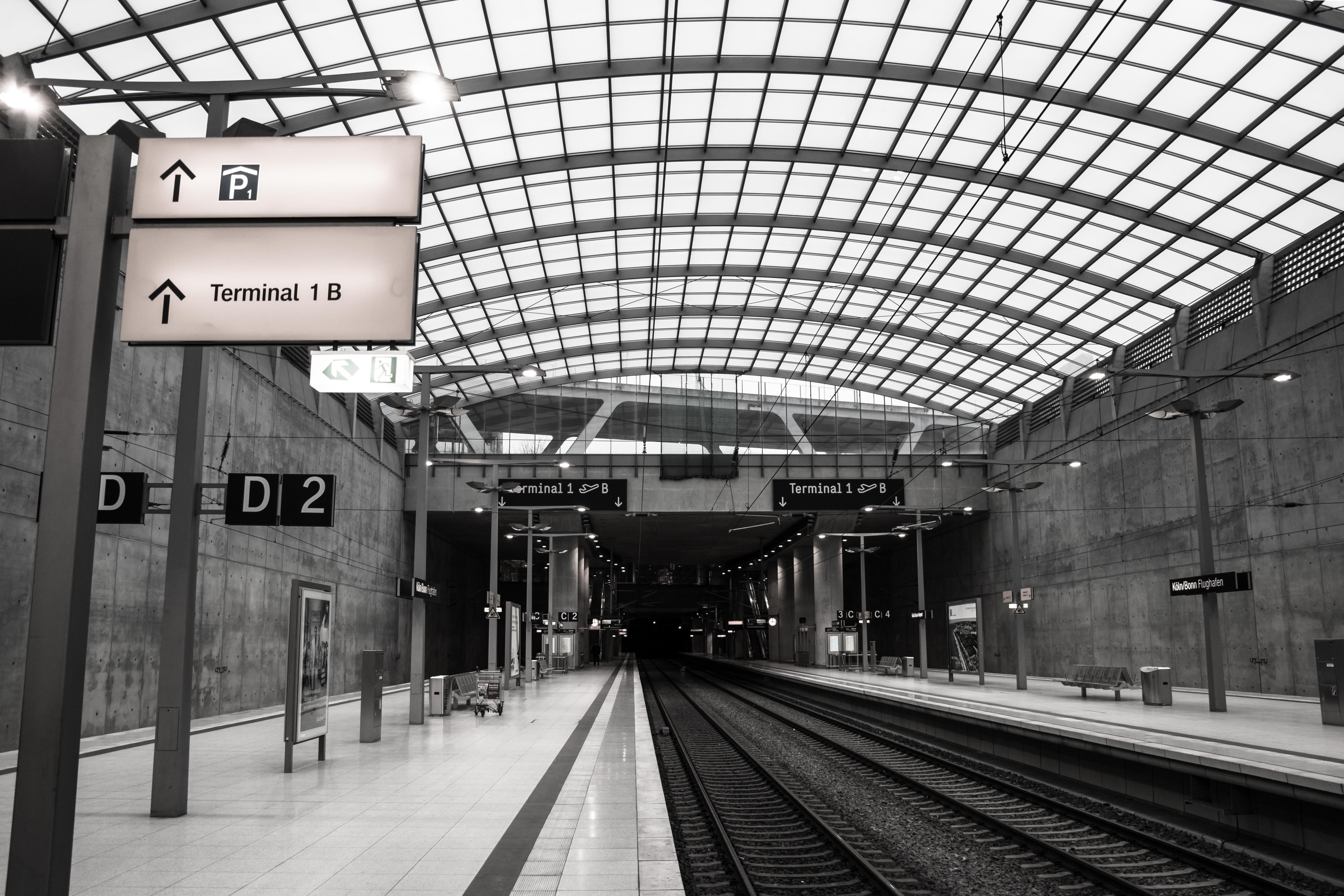 gray scale photo of train station