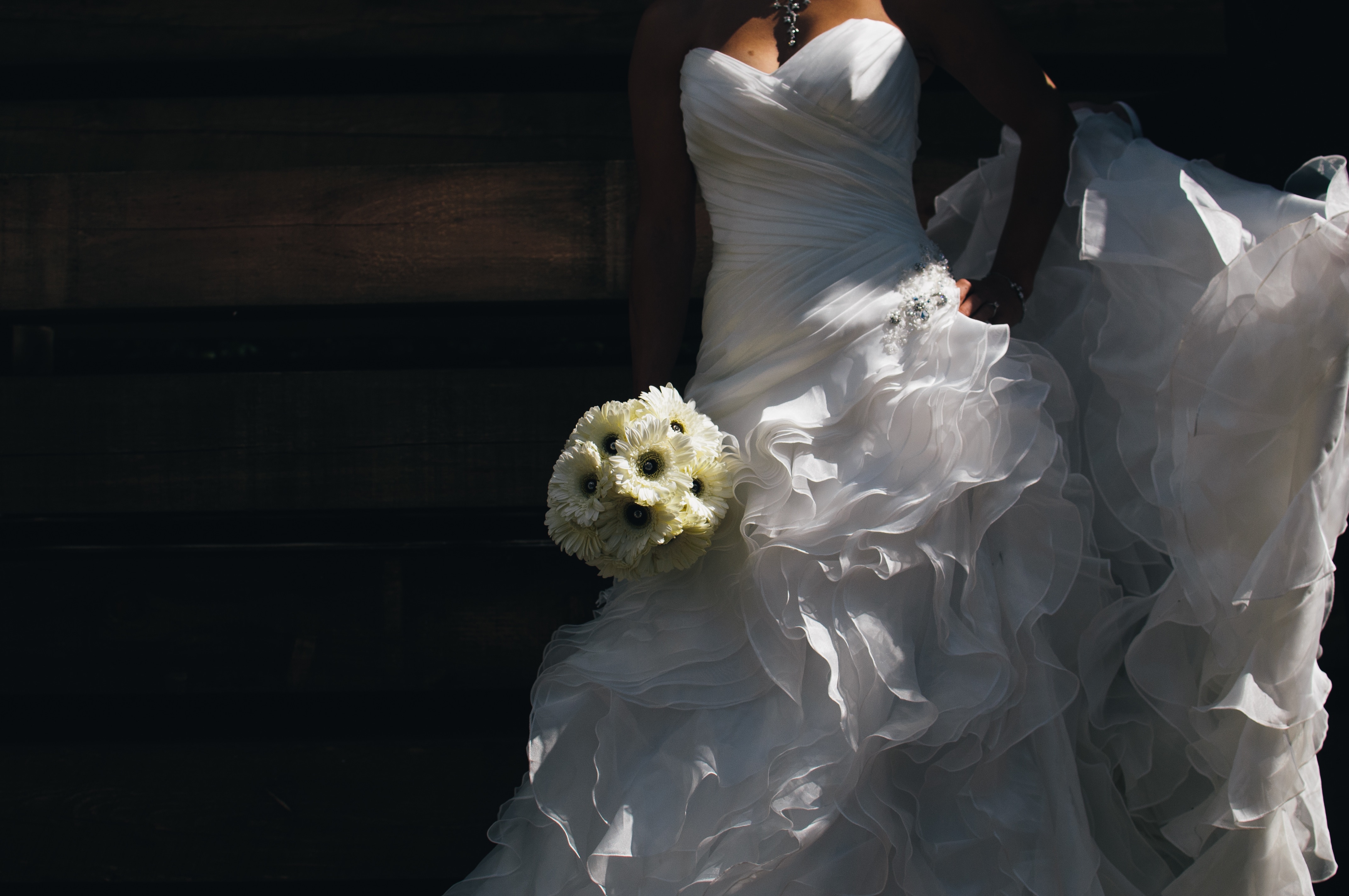 woman wearing bridal gown holding flower bouquet