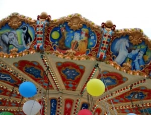brown white and blue carousel swing ride thumbnail