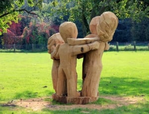 beige wooden statue of childrens thumbnail