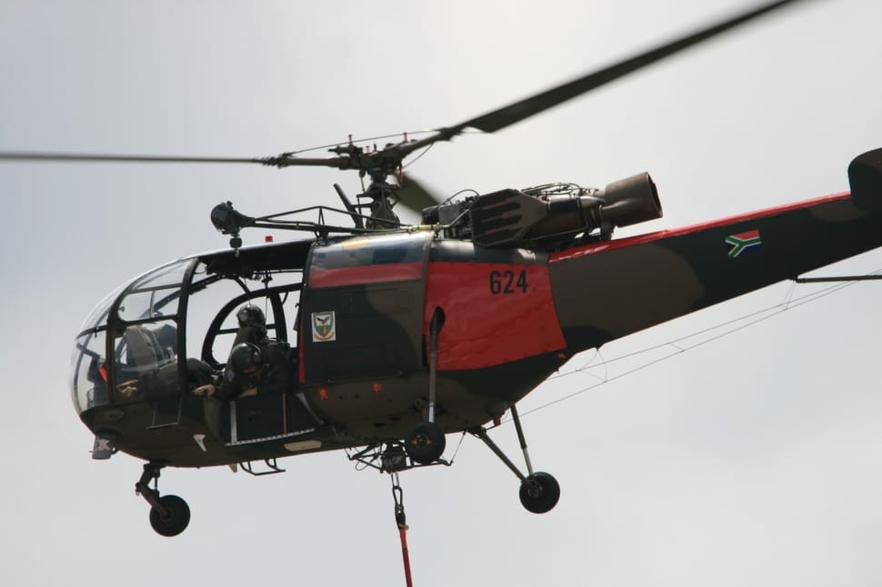 black and red Helicopter flying during day time preview
