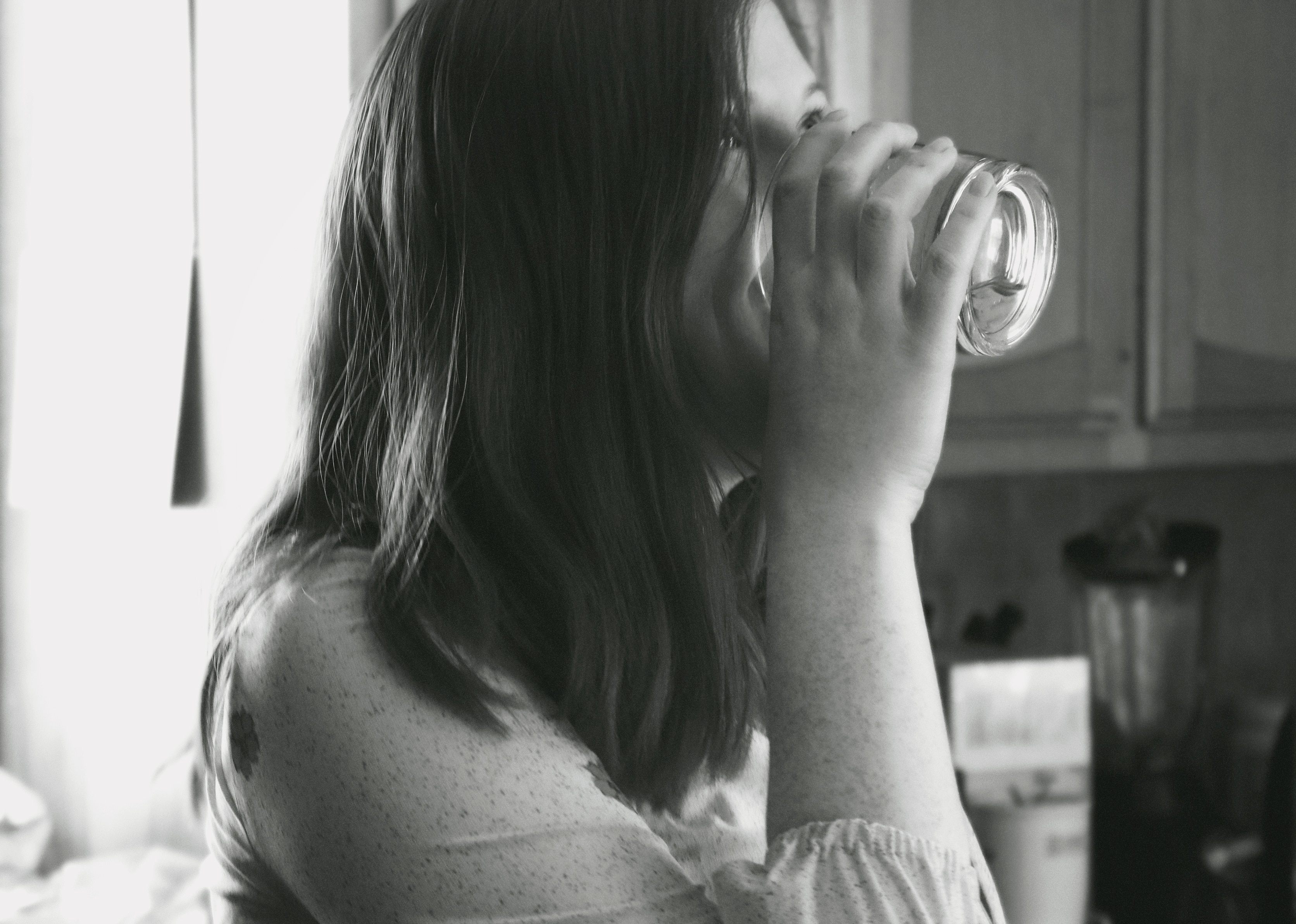woman drinking on rock glass