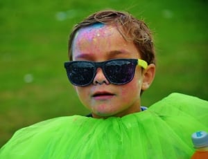 boy with black wayfarer style sunglasses covered with paint thumbnail