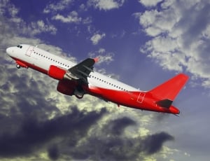 close up photo of red and white passenger plane thumbnail