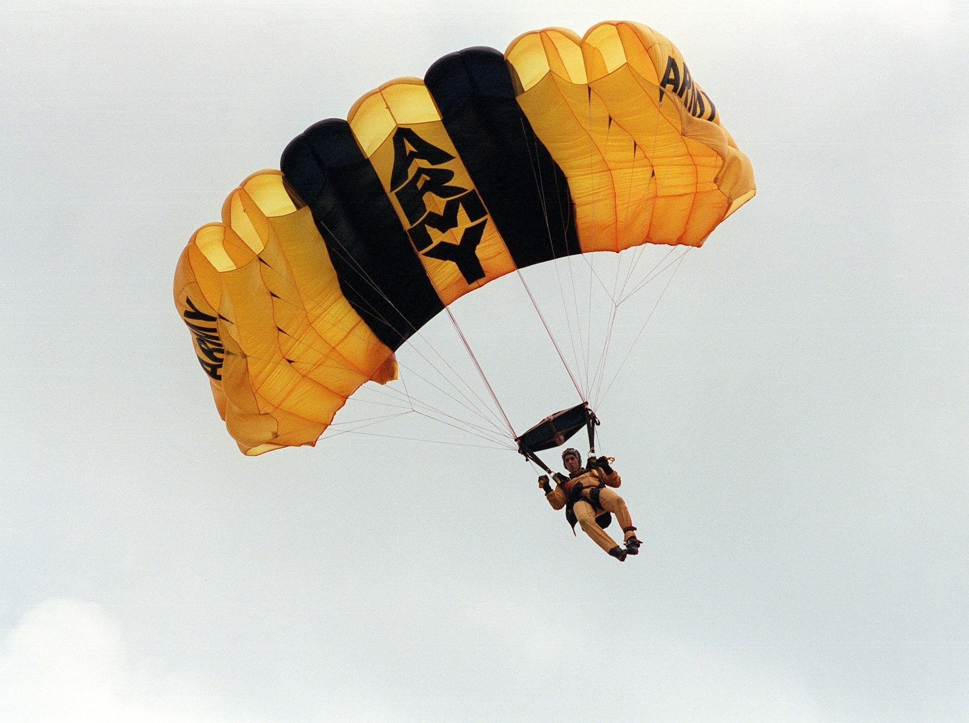 man riding on Army Paraglider during daytime