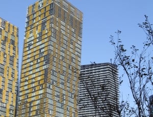 yellow and grey high rise buildings thumbnail