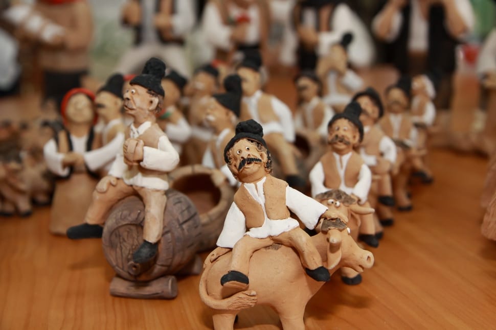 man in white shirt riding cow figurines lot preview