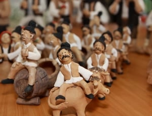 man in white shirt riding cow figurines lot thumbnail