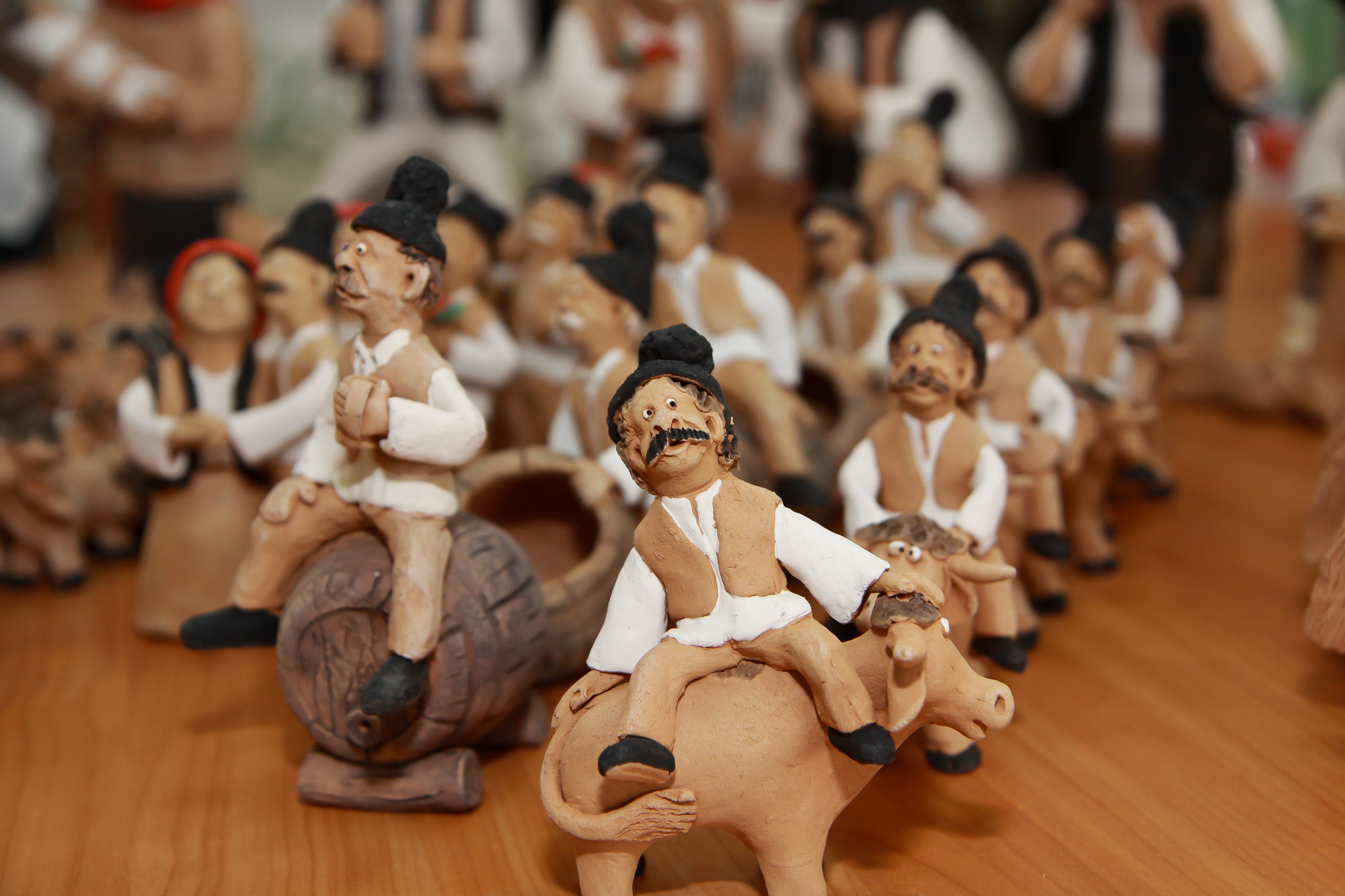 man in white shirt riding cow figurines lot