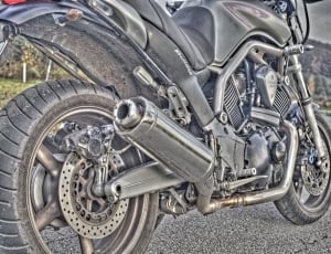 black sports motorcycle on gray rolled asphalt road thumbnail