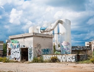 white concrete structure with graffiti thumbnail
