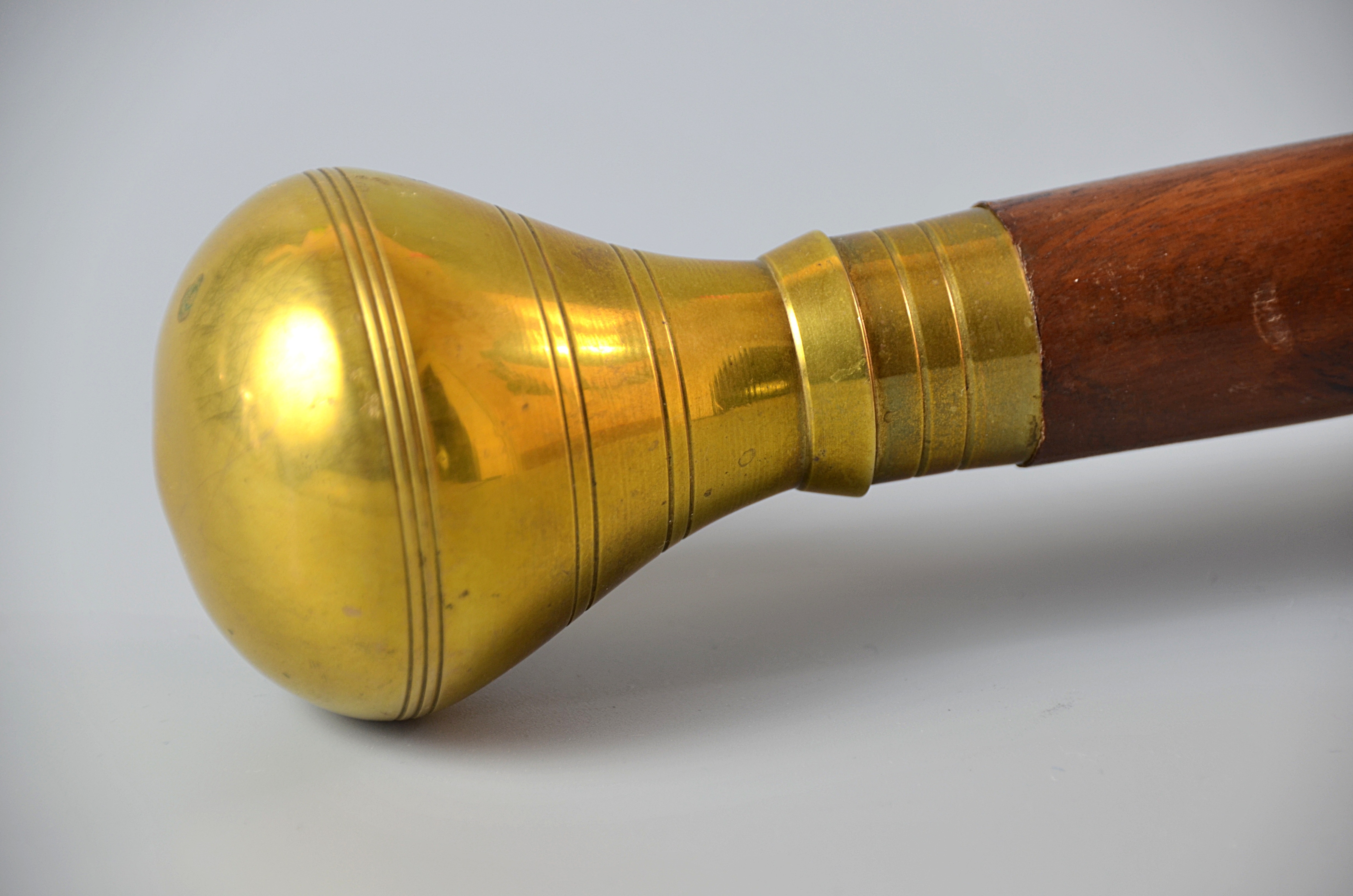 brass and brown wooden curtain rod