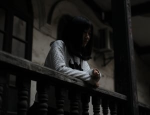 woman in white sweater near handrails thumbnail