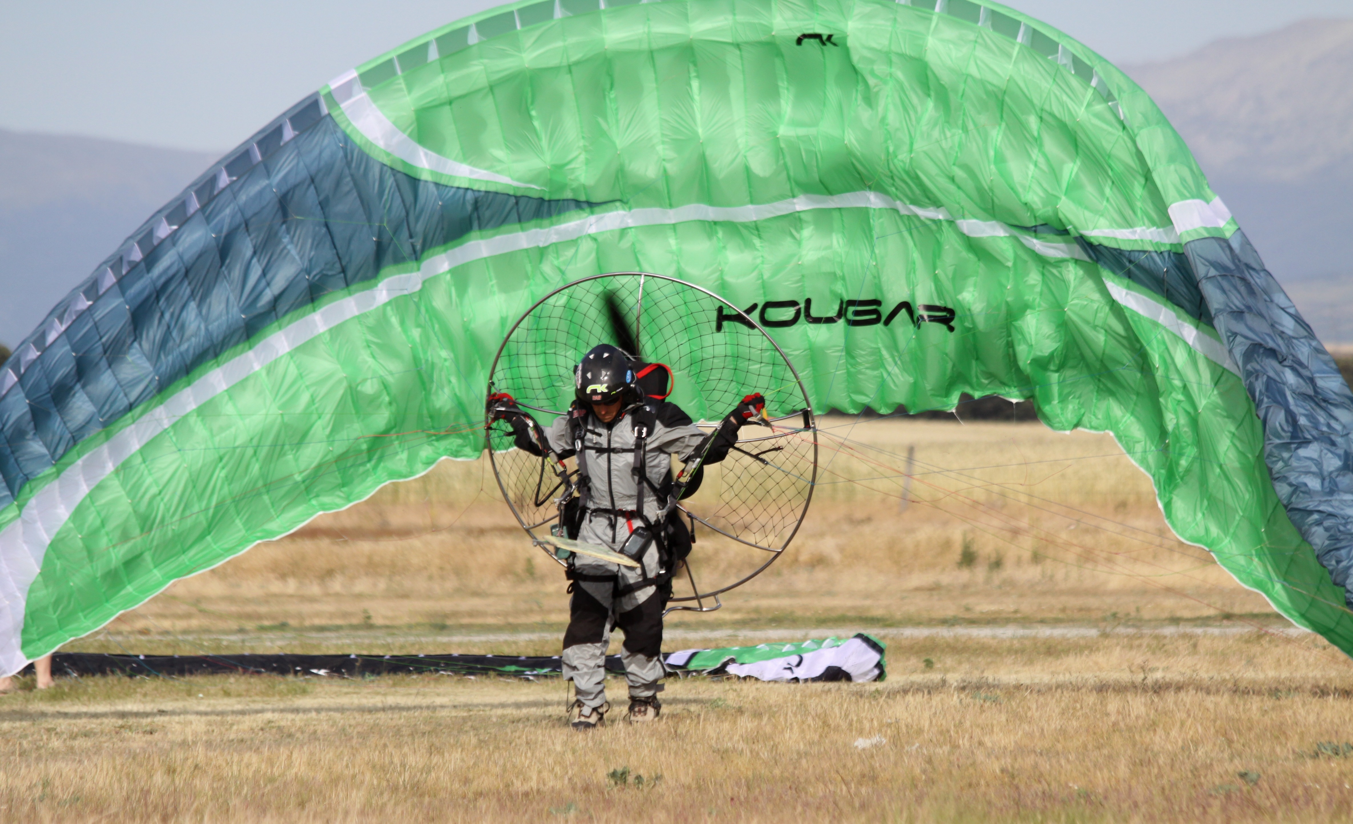green and blue kolgar paraglider
