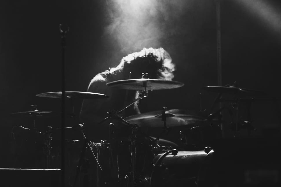 grayscale photo of man playing drum preview