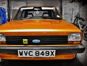 close up photography and selected focus  of orange Ford car thumbnail