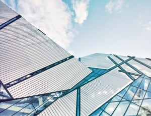 glass panels of a building during a cloudy day thumbnail