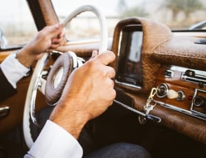 man holding the car steering wheel thumbnail