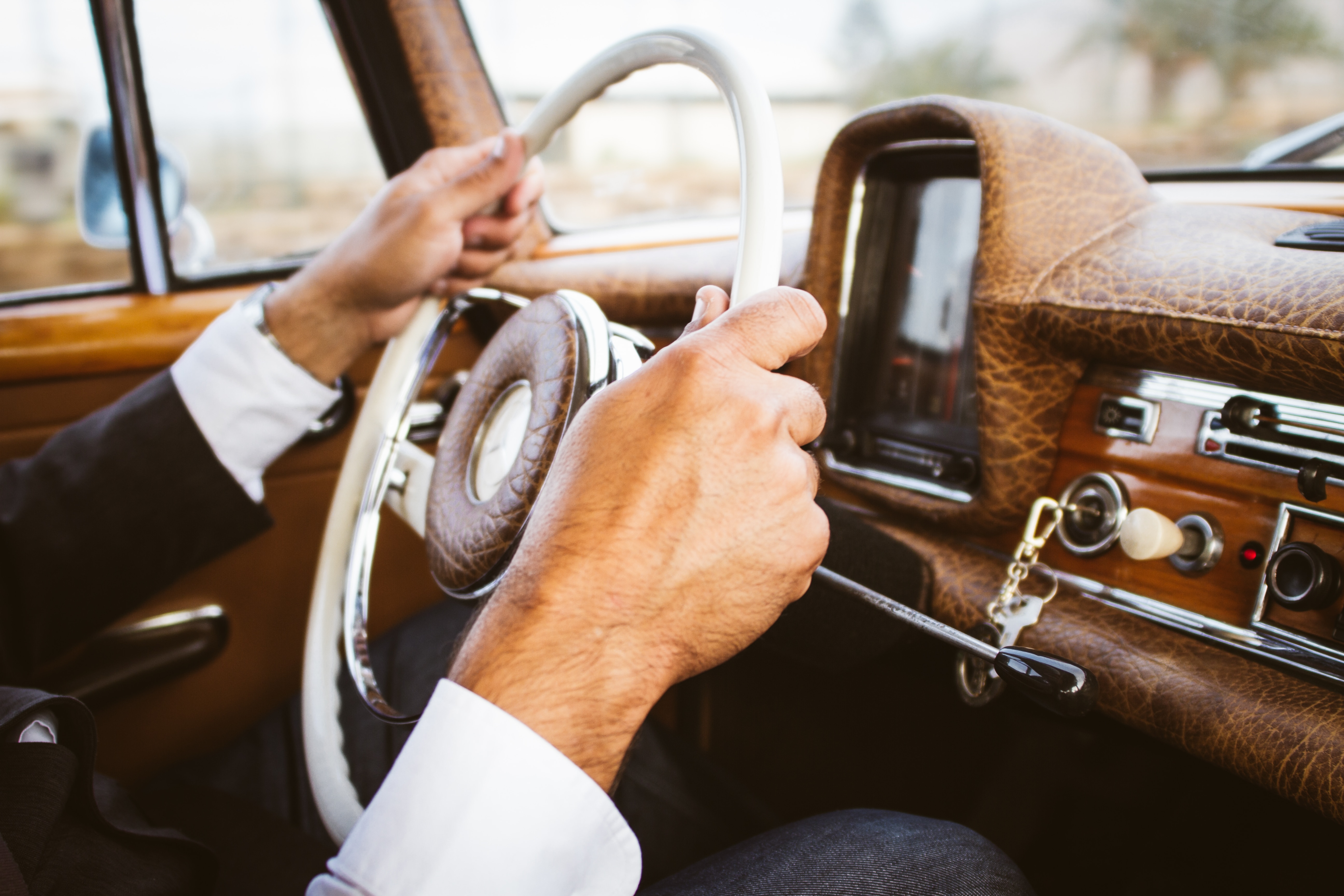 man holding the car steering wheel