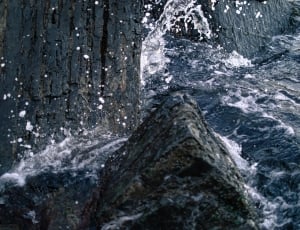 body of water near cliff photo thumbnail