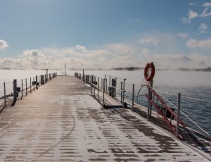 gray and white dock under white and blue cloudy sky during daytime thumbnail