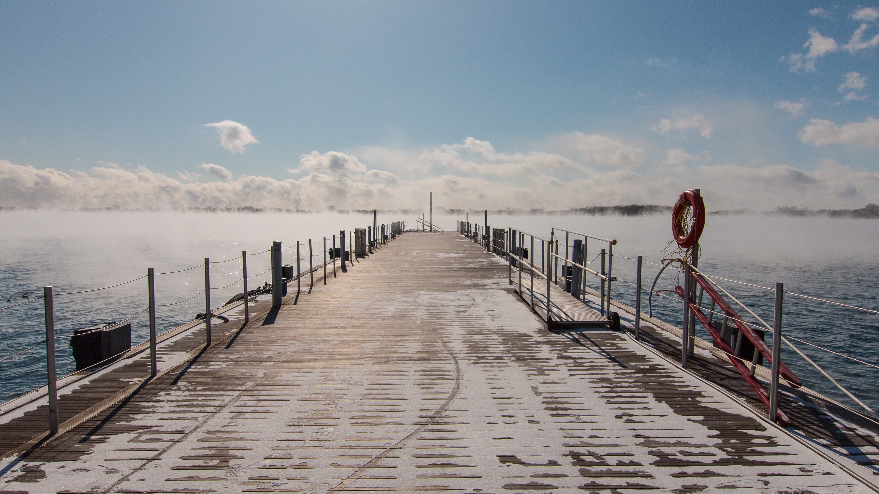 gray and white dock under white and blue cloudy sky during daytime