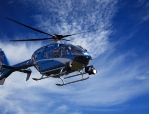 blue and white helicopter during daytime thumbnail