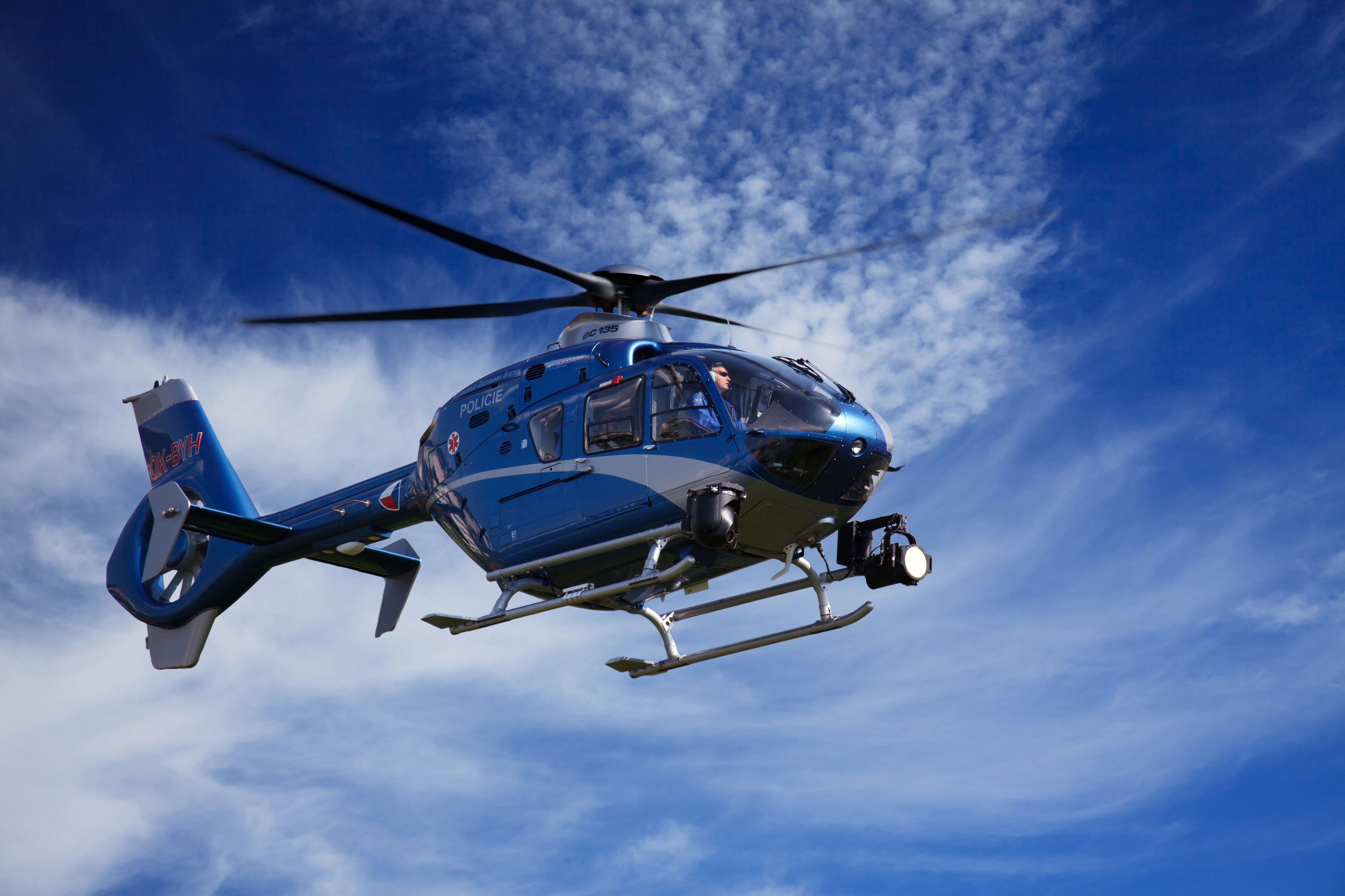 blue and white helicopter during daytime